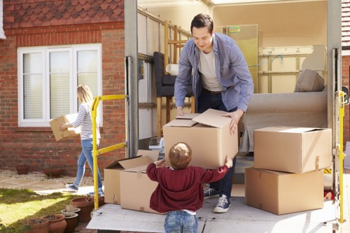 Staff member securing furniture with straps inside a van