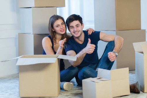 A removals team handling fragile items in a Bexleyheath flat