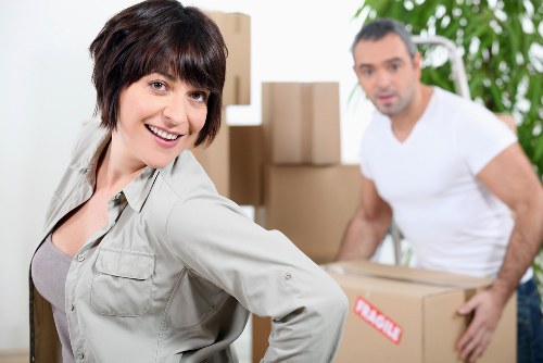 Mover wearing PPE while carrying an item carefully