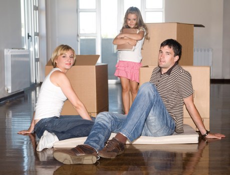 Professional movers handling furniture during a student move